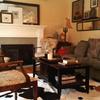 Living room after . . .  
Sofa was moved against the wall,  China Cabinet removed from living room, near kitchen (not shown) grouped arts and mirrors from many locations in the house to one wall behind sofa,  Cow hide rug added interest to the room.    